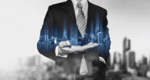 a holograph of skyscrapers in a man's hand illustrating how listings can turn into social media leads