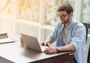 Man with glasses sitting in front of computer