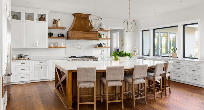 White kitchen with wooden chairs and accents