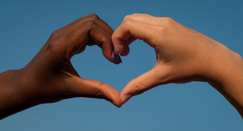 Black and white hands in heart shape, interracial friendship